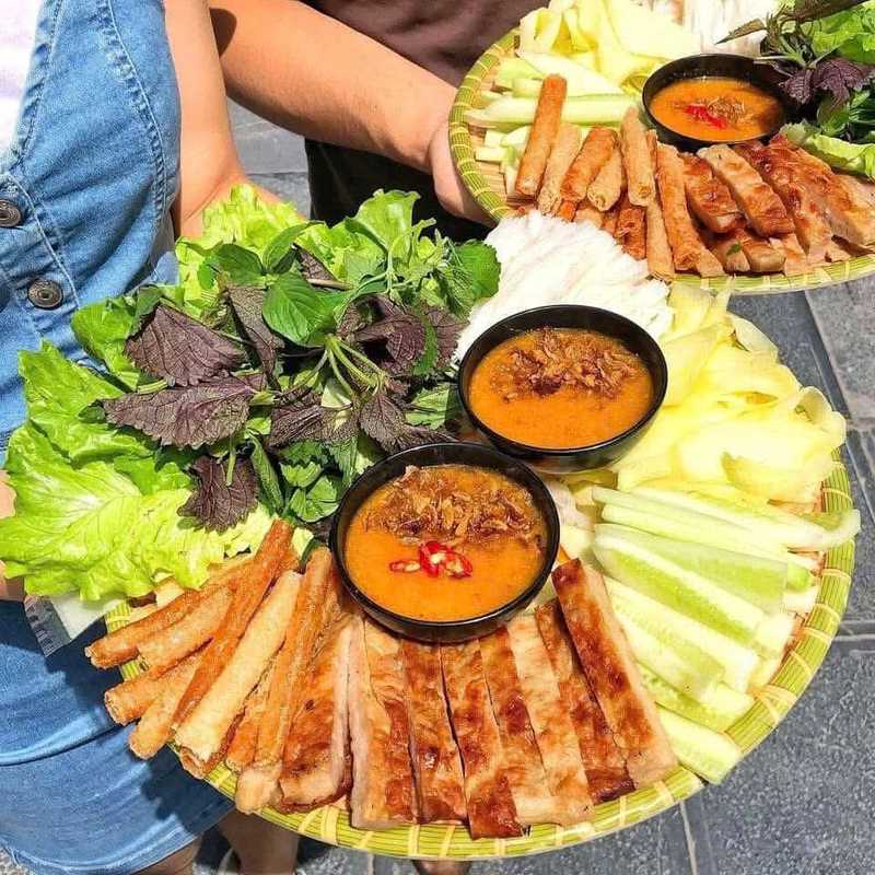Mẹt nem nướng kèm ram cuốn chiên, rau sống, dưa leo và hai chén nước chấm