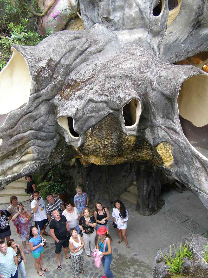 Khối tượng hình đầu thú lớn và du khách trong Crazy House